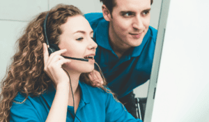 Two IT support professionals working together on remote maintenance and network monitoring.