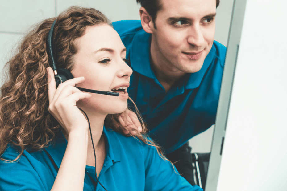 Two IT support professionals working together on remote maintenance and network monitoring.