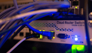 Networking hardware and data cables configured in a server rack for a live system migration.
