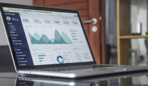 Data analytics dashboard showing active user metrics, area graphs, and performance charts on a laptop screen.