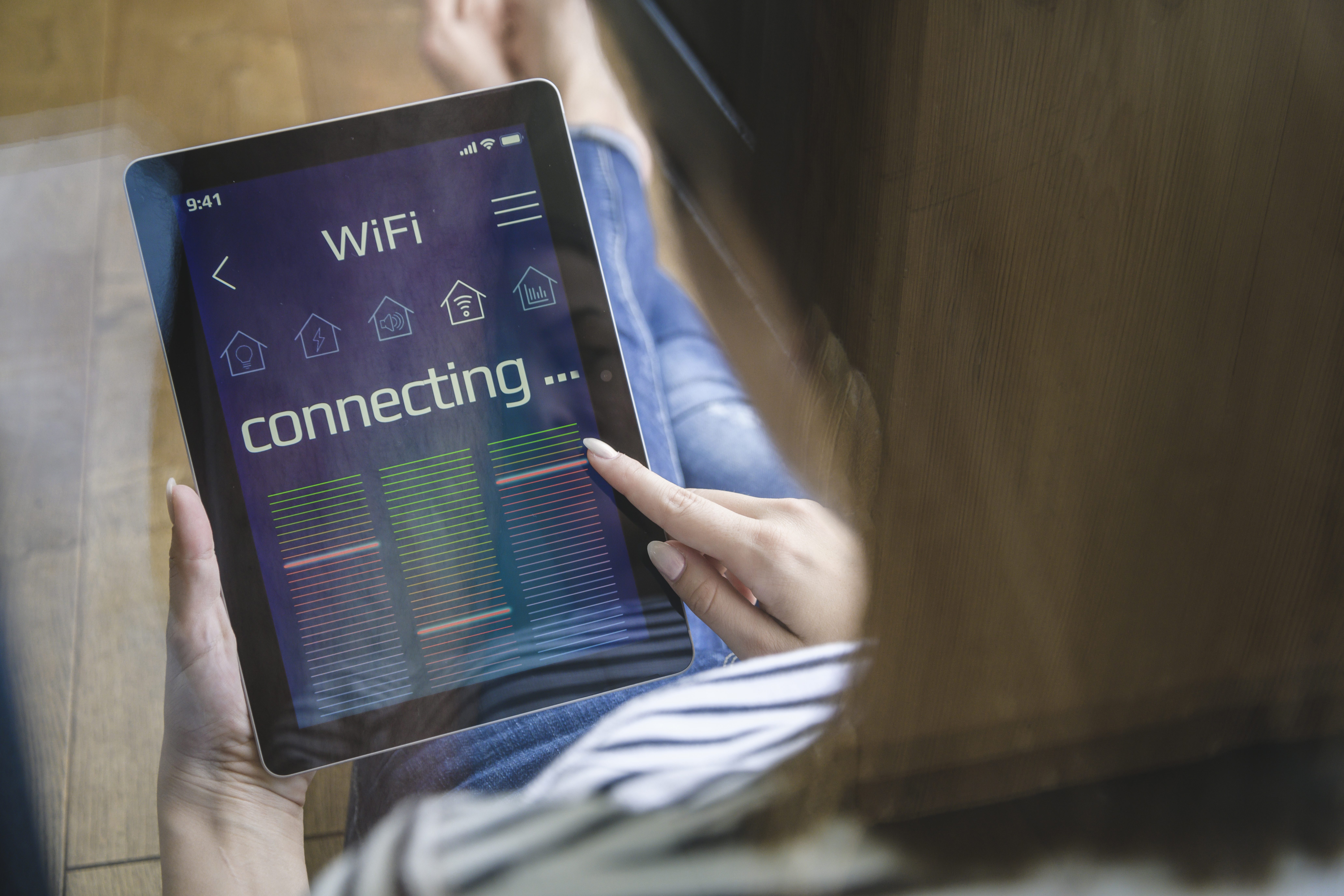Young woman with tablet with smart home control functions